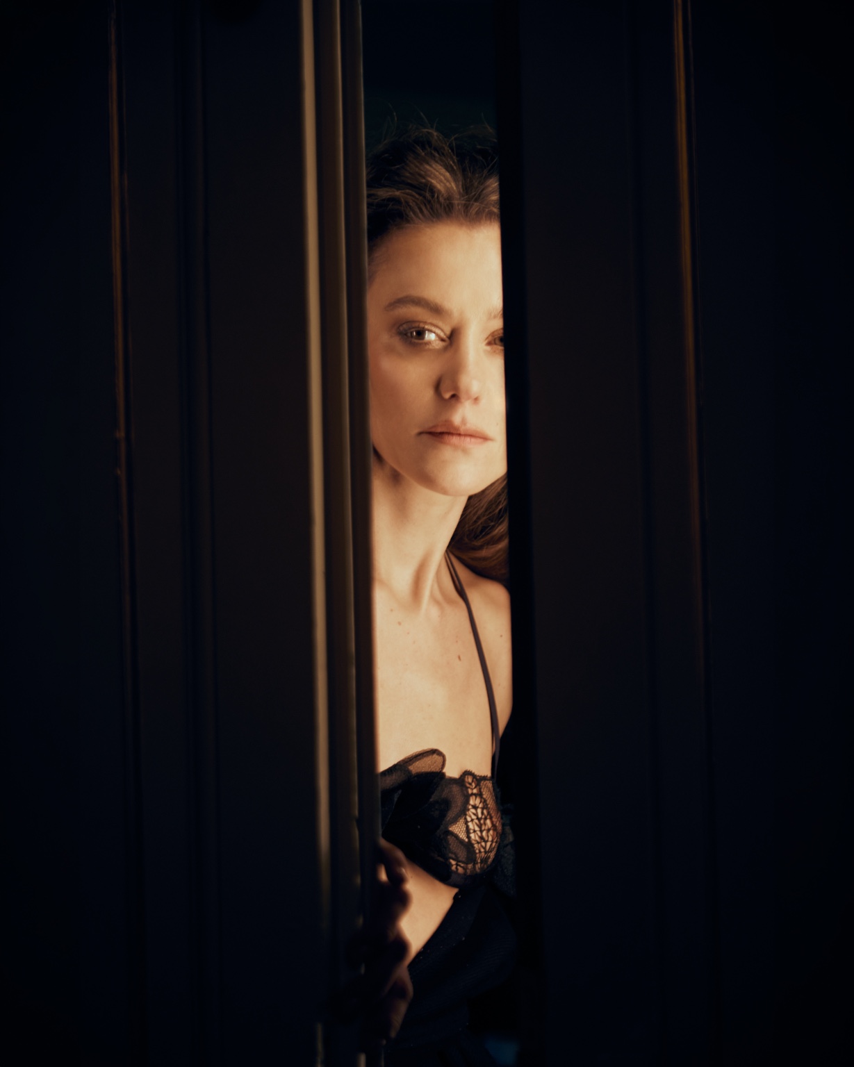 Lourdes Fernández framed between dark doors in My Butler