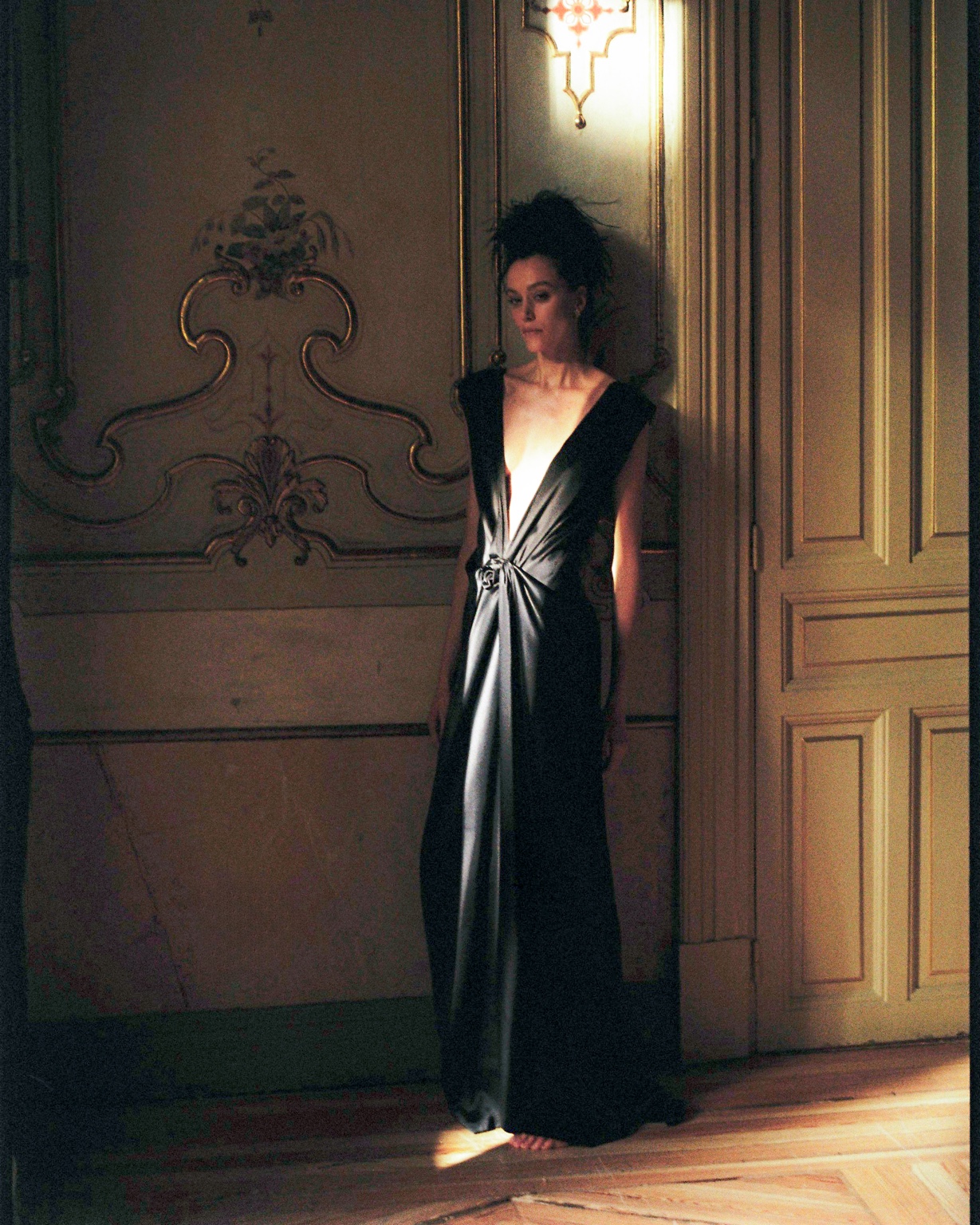 A woman alone by a doorway